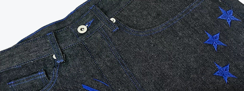 Script Embroidered Star Raw Denim Flare Jeans - Black star embroidery and pocket detail